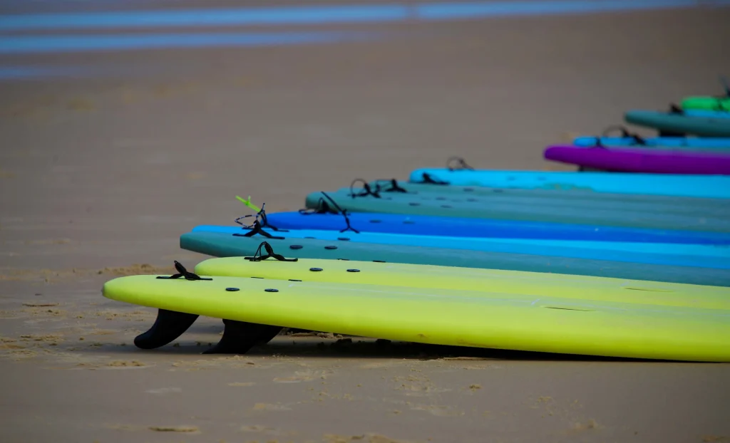 Surfing in Morocco for Beginners: A Local’s Ultimate Guide a row of colorful surfboards on the banana beach in Morocco